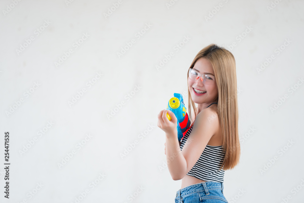 Asian sexy woman with gun water in hand on white background,Festival songkran day at thailand,The best of festival of thai,Land of smile Asian sexy woman with gun water in hand on white background,Festival songkran day at thailand,The best of festival of thai,Land of smile