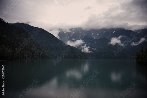 Rainy mysterious morning on a mountain lake