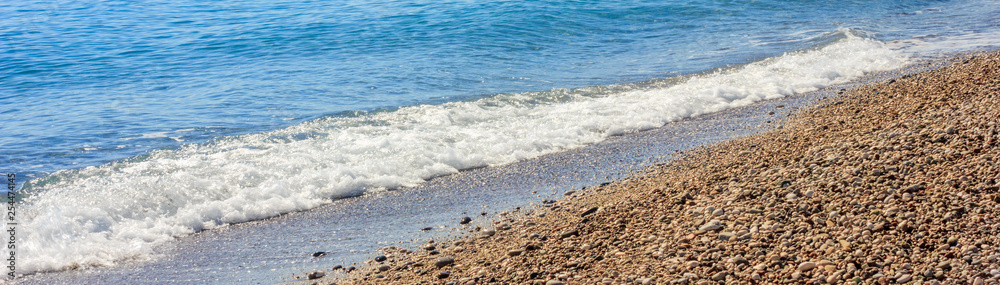 Mediterranean landscape in Antalya, Turkey. Blue sea, waves and pebble sandy beach Mediterranean landscape in Antalya, Turkey. Blue sea, waves and pebble sandy beach
