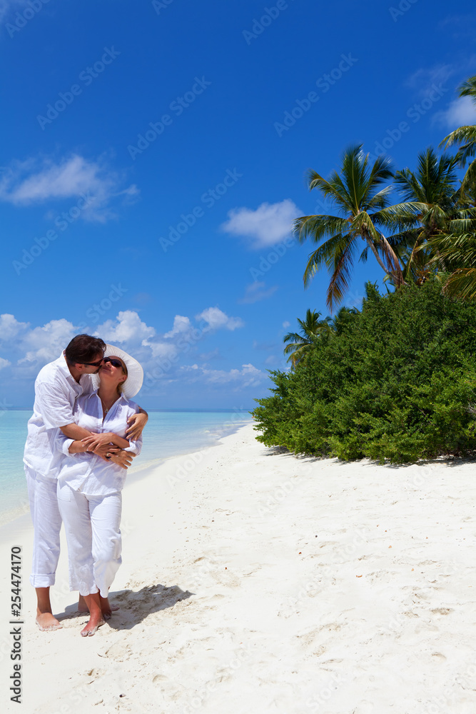 Happy Couple sharing an embrace on the Beach.Copy space 