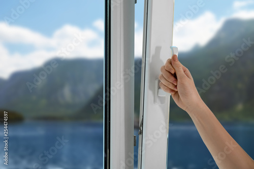Woman opening new modern window, closeup view