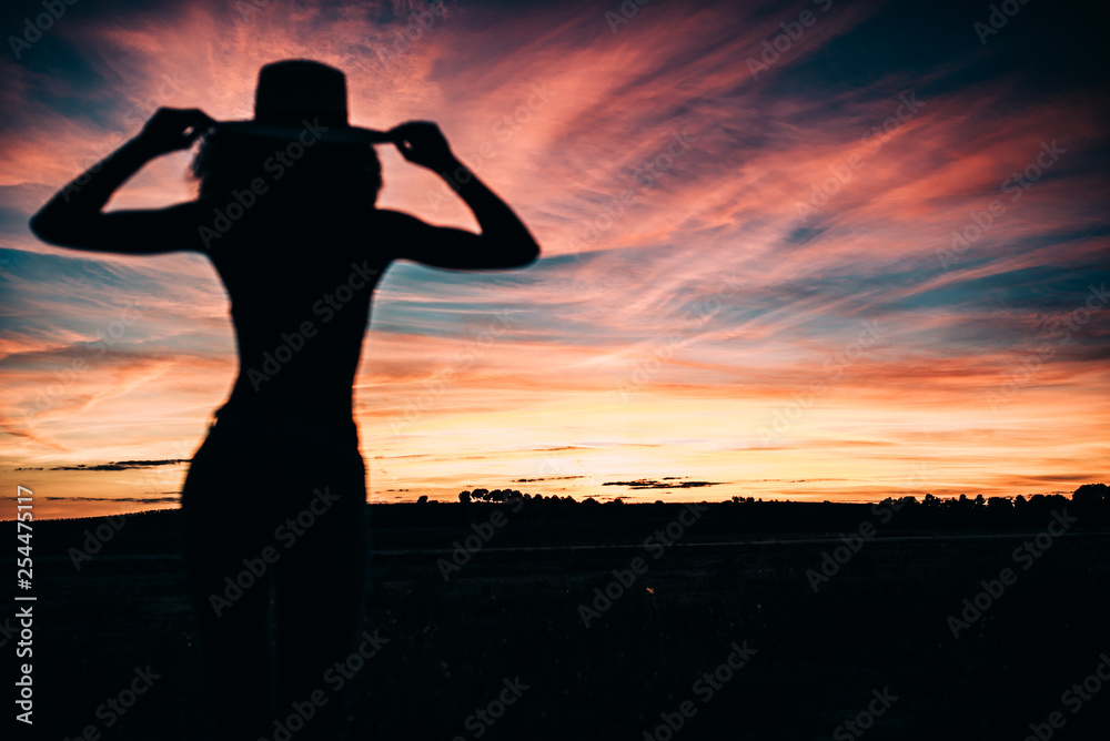 Woman silhouette in the beautiful sunset