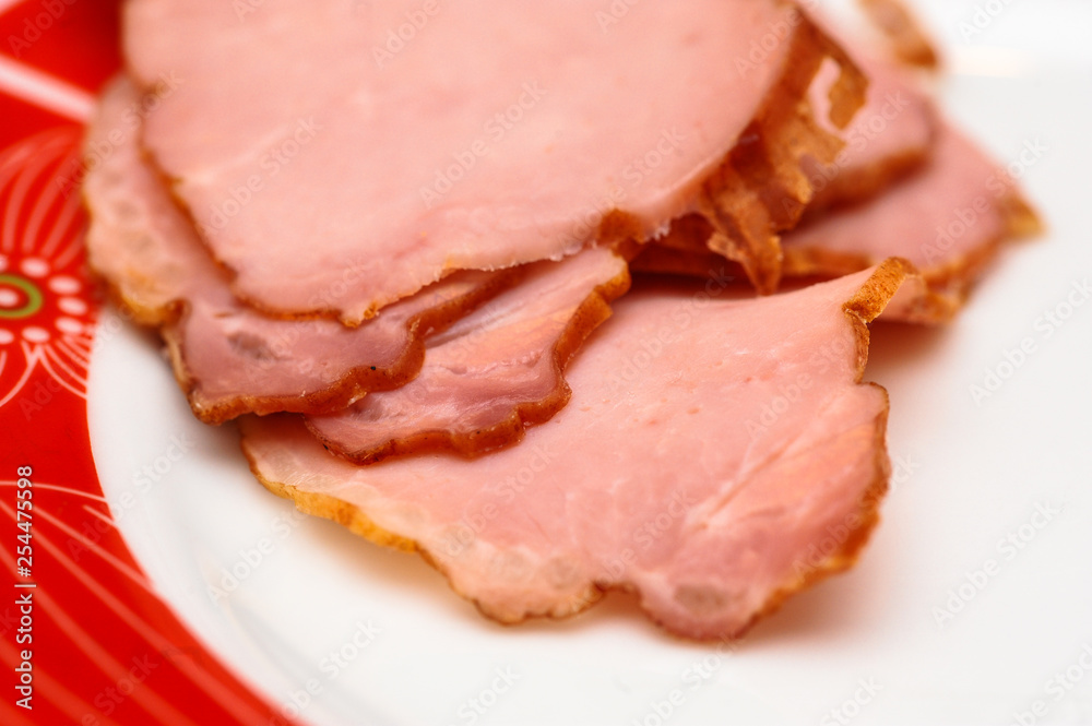 Plate with tasty sliced baked ham on table