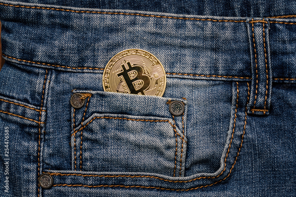 Bitcoin cryptocurrency in the pocket of jeans. Concept with bitcoin. Bitcoin cryptocurrency in the pocket of jeans. Concept with bitcoin.
