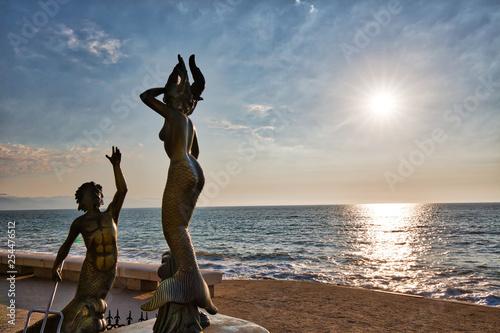 Puerto Vallarta, Mexico-20 April, 2018: Famous sculptures on scenic ocean boardwalk (El Malecon) at sunset