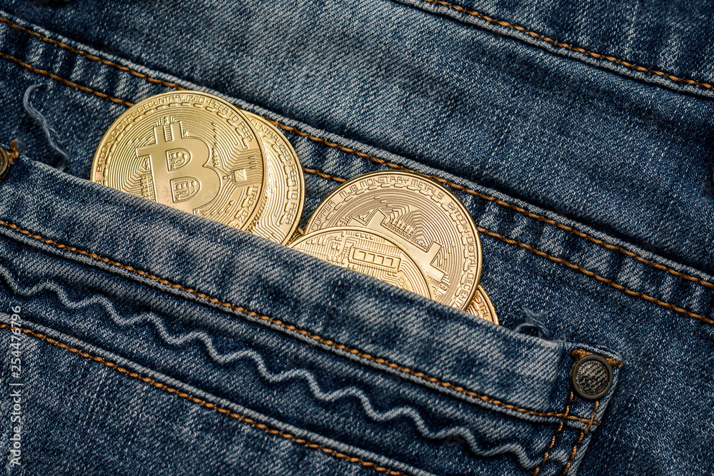 Bitcoin cryptocurrency in the pocket of jeans. Concept with bitcoin. Bitcoin cryptocurrency in the pocket of jeans. Concept with bitcoin.