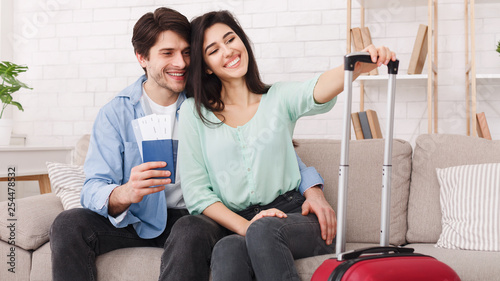 Loving couple with passports and tickets waiting for taxi © Prostock-studio