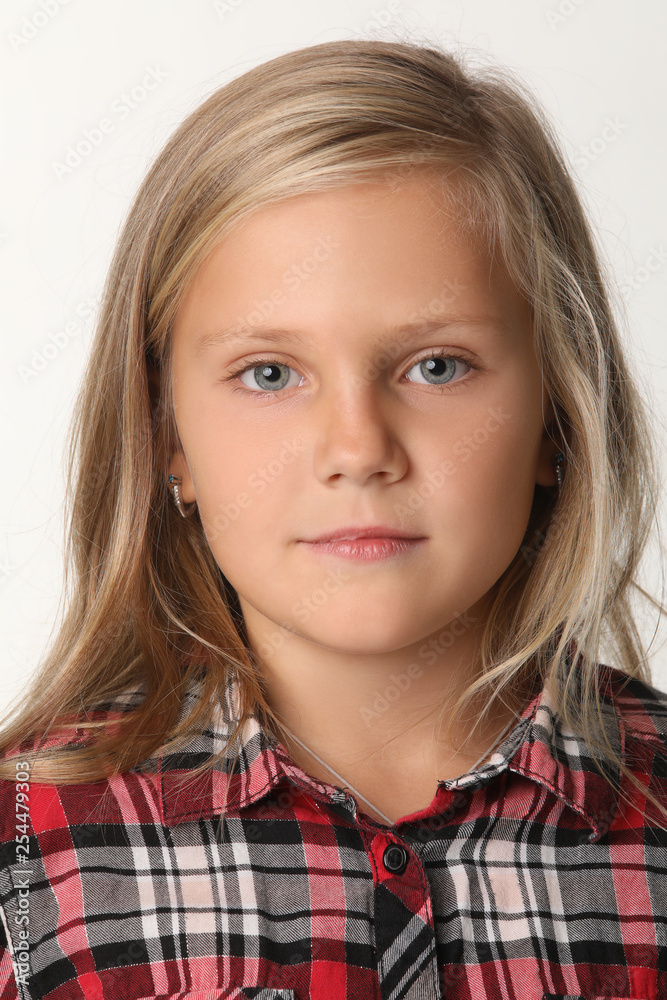 Close up of a portrait of a girl with blue eyes and blond hair. White background Close up of a portrait of a girl with blue eyes and blond hair. White background