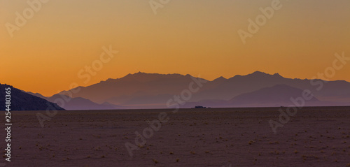 Yellow colored sky and blue distant mountains after sunset