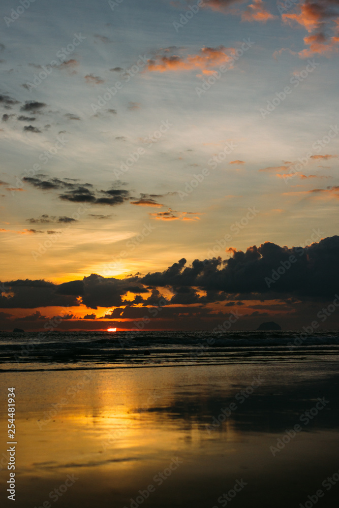 Unforgettable sunrise near the sea on vacation, beautiful clouds. Waves at sea