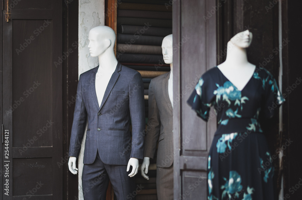 Two male mannequins stand in the door opening looking as disturbed people and a mysterious woman