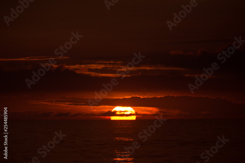 Sun behind clouds on a fired sky 2