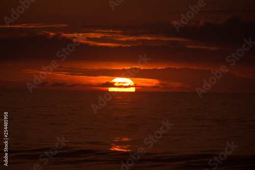 Sun behind clouds on a fired sky 1