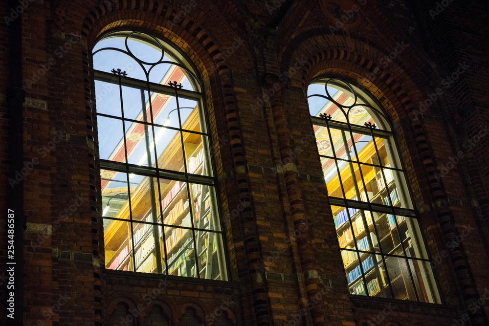 view through night windows into library with books in Copenhagen in Denmark