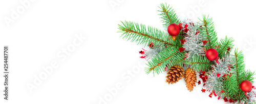 Christmas decoration baubles with branches of fir tree on white. Free space for text. Wide photo.