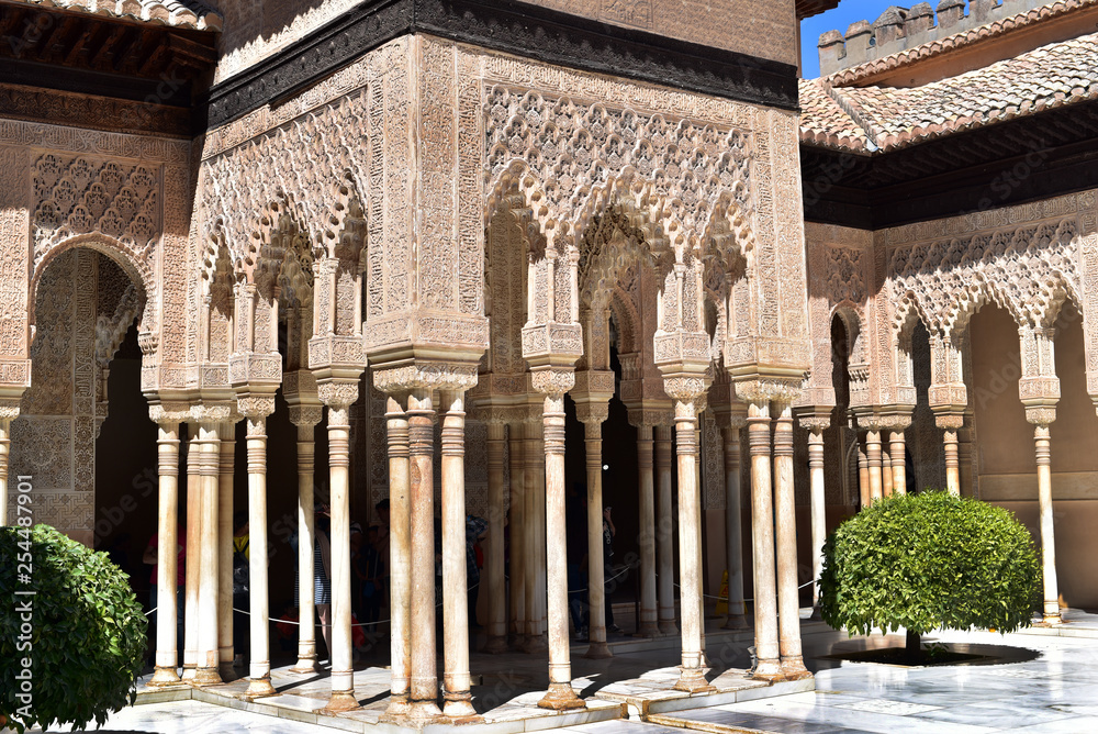 Carved columns in an interior courtyard named Court of the Lions inside La Alhambra in Granada, Spain