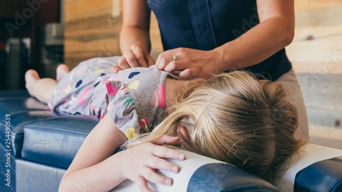 Young Girl Being Adjusted by Chiropractor photo