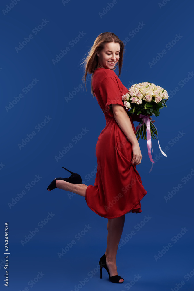 Young woman holding flower bouquet in the field - a Royalty Free Stock  Photo from Photocase
