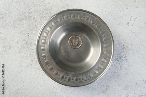 Vintage metal plate on concrete background.