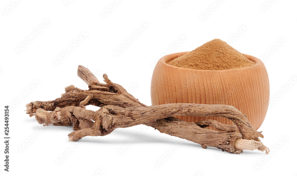 Dry roots of chicory and crushed chicory in wooden bowl isolated on white background. A substitute for coffee.