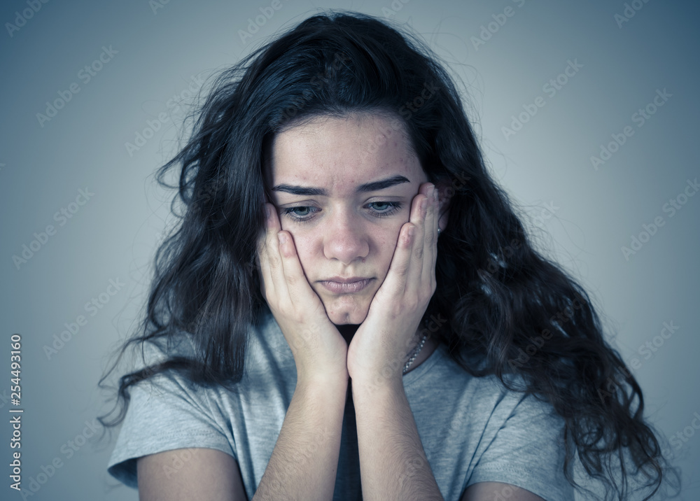 Close up portrait of teenager female suffering depression. Sad face, unhappiness human emotion.