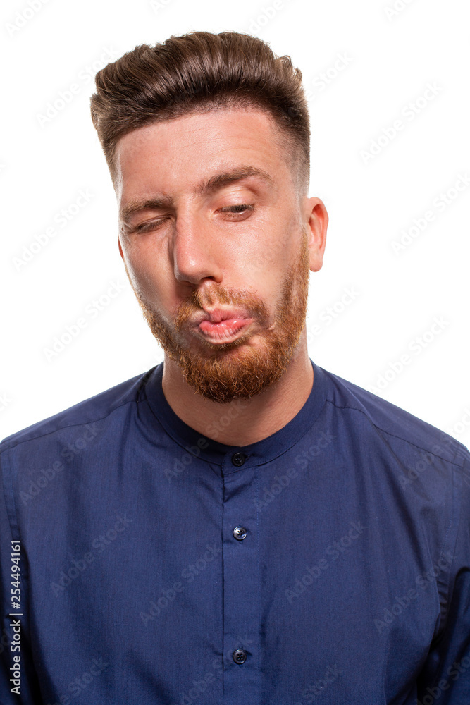 Obraz premium Attractive young man wearing blue shirt, isolated over a white background.