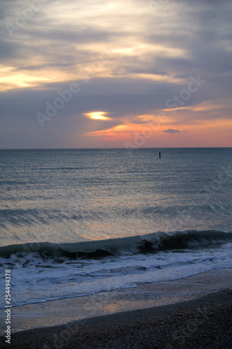 sunrise over the sea sunset  sea  beach  sky  ocean  water orange  sand  nature waves coast  landscape  horizon  light  wave  beautiful 