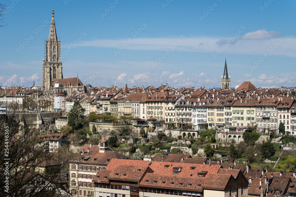 Bern skyline with the Cathedral and houses from the old town on a cliff on a sunny day in Switzerland capital city