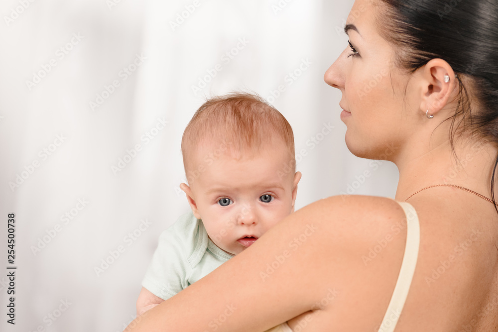 Portrait of young loving mother holding her newborn child Portrait of young loving mother holding her newborn child
