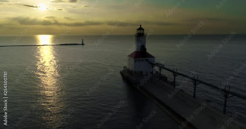 Pier and Lighthouse Aerial View with Pier Jumpers on Lake Michigan Pier and Lighthouse Aerial View with Pier Jumpers on Lake Michigan