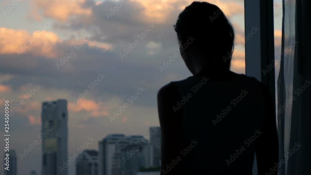 Silhouette of woman admire view from window, super slow motion 240fps Silhouette of woman admire view from window, super slow motion 240fps