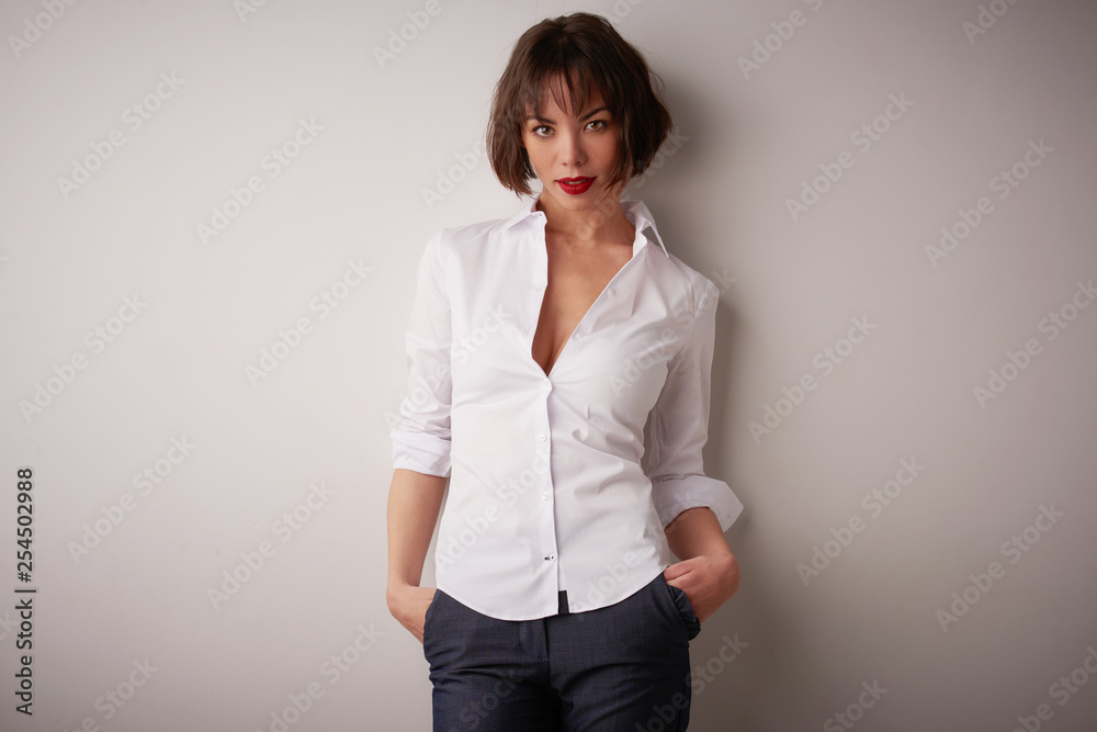 Studio portrait of beautiful young woman standing at isolated bacgkround