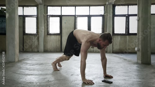 Shirtless man doing push up variations photo