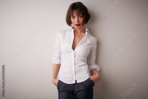 Studio portrait of beautiful young woman standing at isolated bacgkround