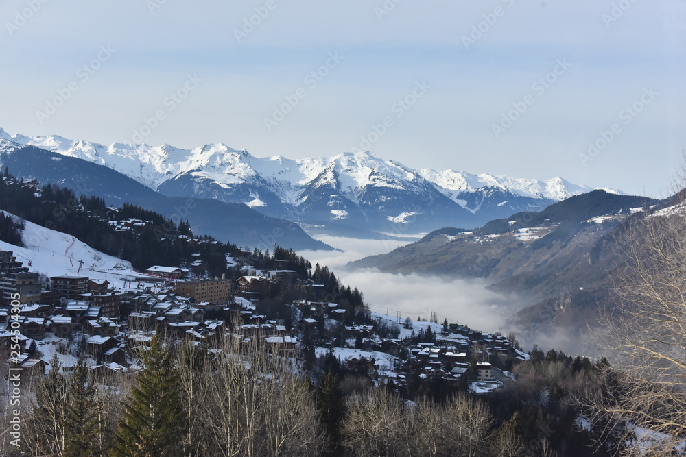 Winter scenery with clouds and snow on the mountains 