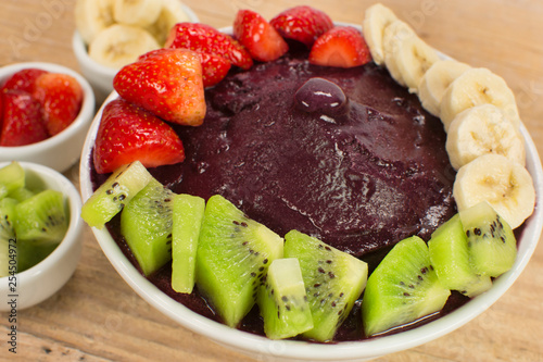Brazilian acai and fruits in wood background close