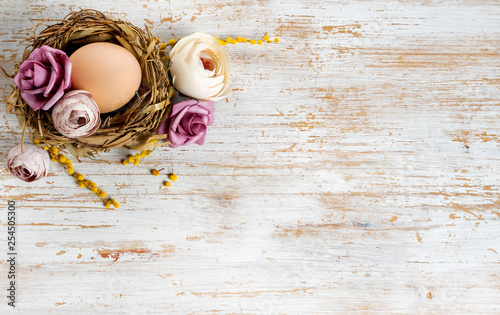 Easter egg and flowers on wooden background