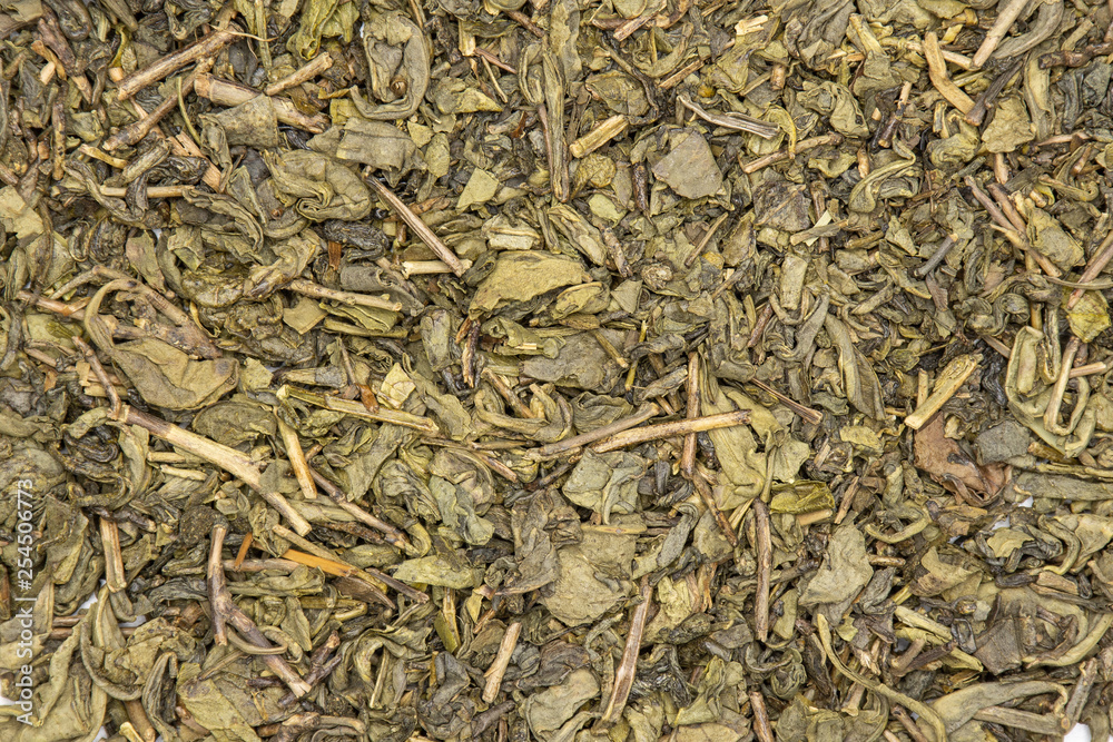 Lot of pieces of dry green tea closeup flatlay isolated Lot of pieces of dry green tea closeup flatlay isolated