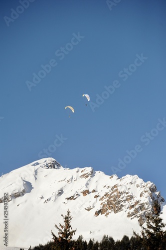 Winter scenery with paragliders in the mountain 
