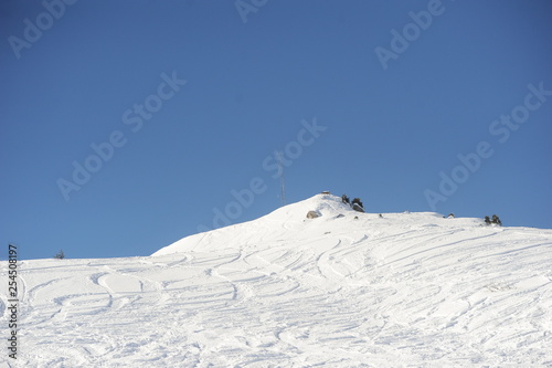 Ski slope with ski tracks in winter © raeva