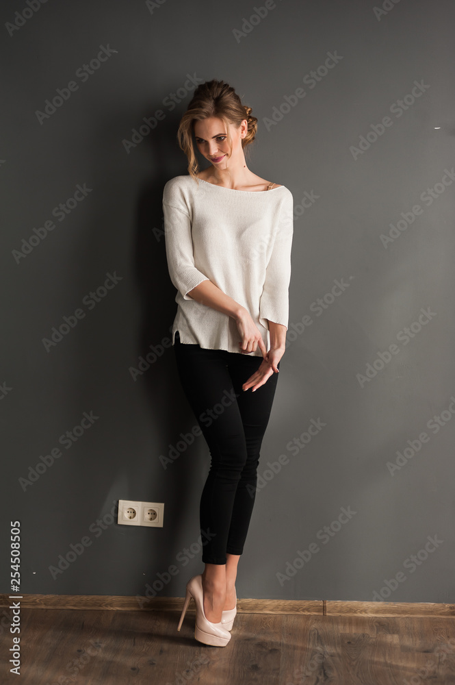 Beautiful woman wearing casual standing near grey wall Beautiful woman wearing casual standing near grey wall