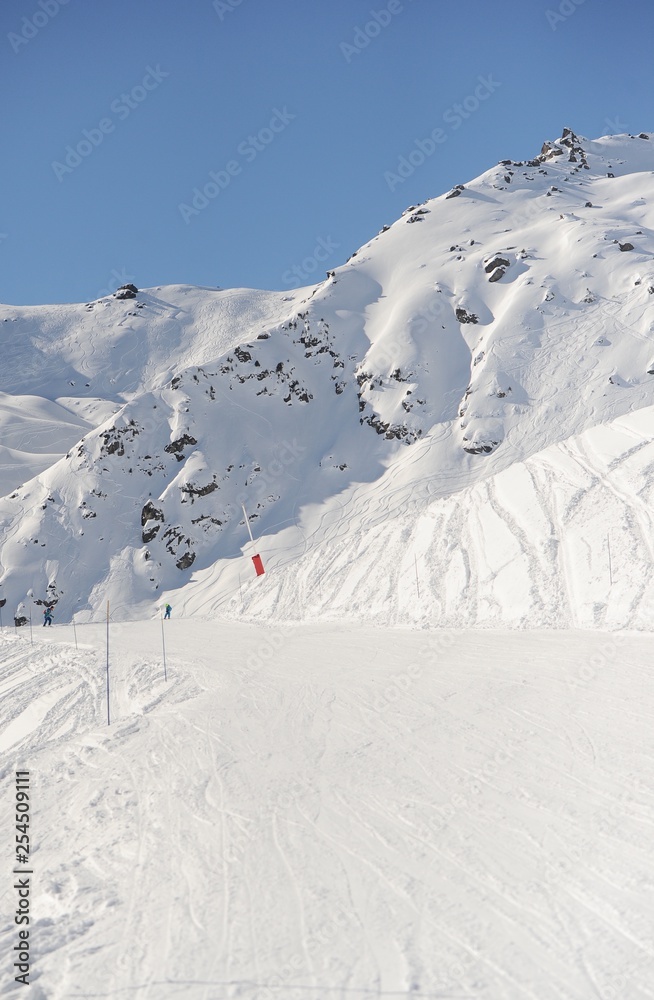 Empty ski slope with snow in French alps 