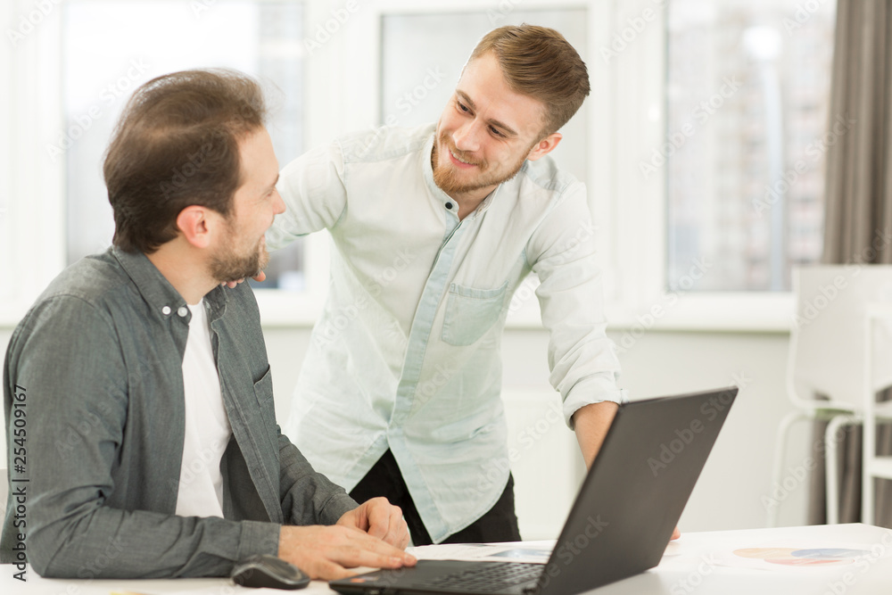 Two businessmen working at the office together Two businessmen working at the office together