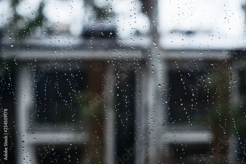 Raindrops on the glass on the background of the house