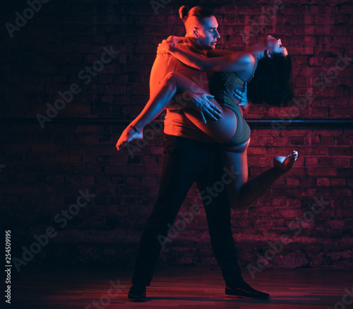 Passionate couple perform incendiary dance in night club