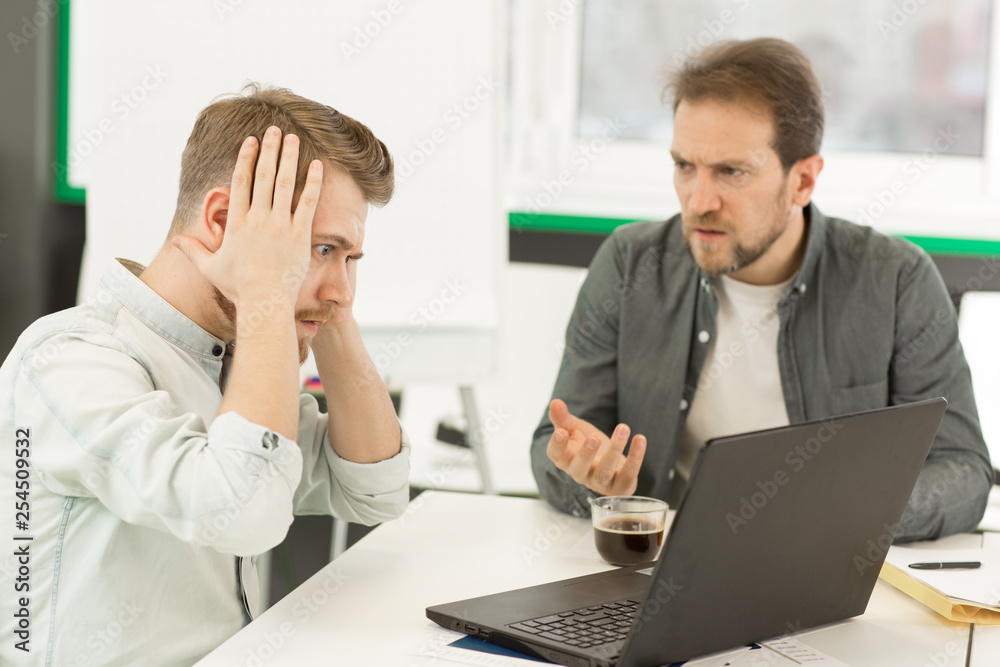 Two businessmen working at the office together Two businessmen working at the office together