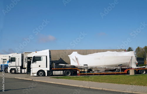 Truck with a special trailer for boat transport. Land transport of boats and yachts.