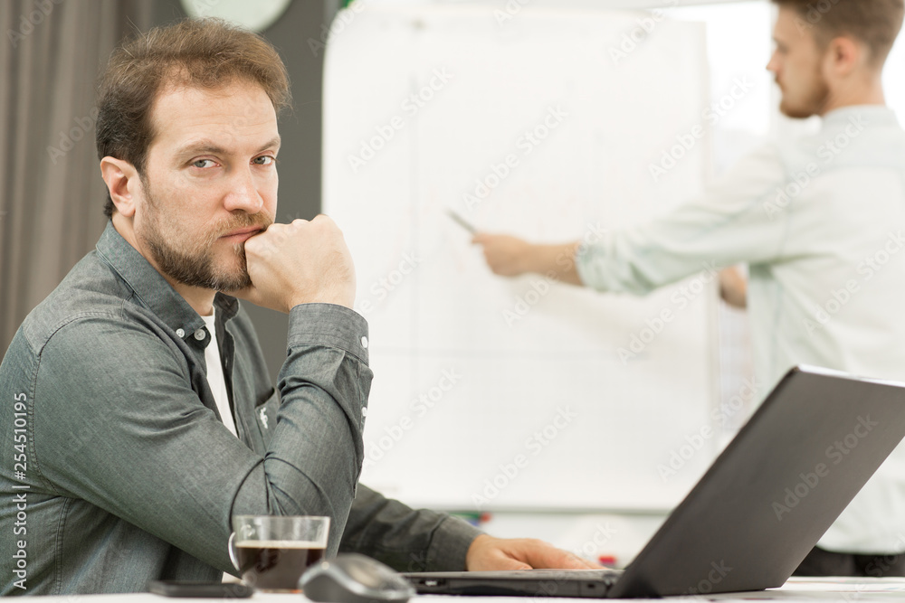 Two businessmen working at the office together Two businessmen working at the office together