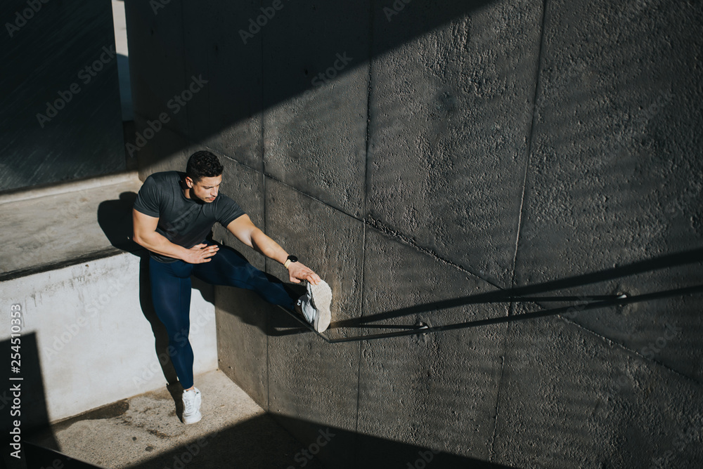 Fototapeta premium fitness man doing stretching exercises