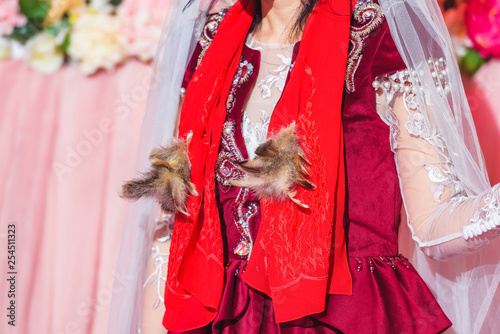 Wedding ceremony. Wedding. Decor with fresh flowers. Bride in Kazakh national costume. Wedding in the Kazakh traditions. The dress is a Burgundy color. photo